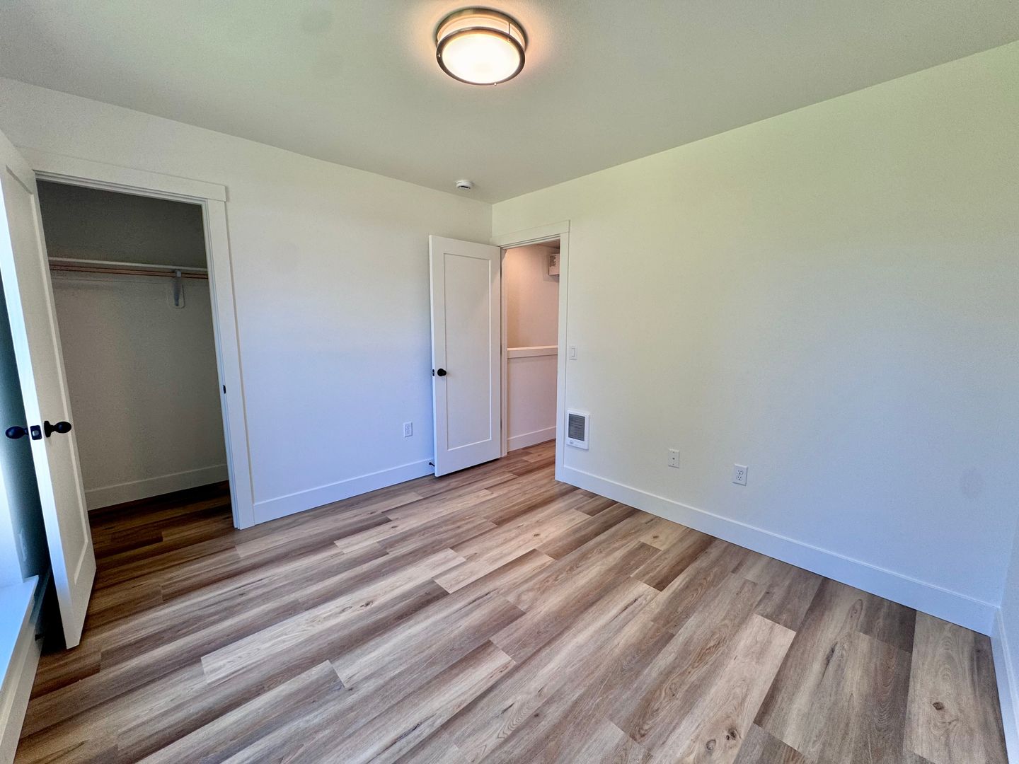 Bedroom with open closet and built-in shelving