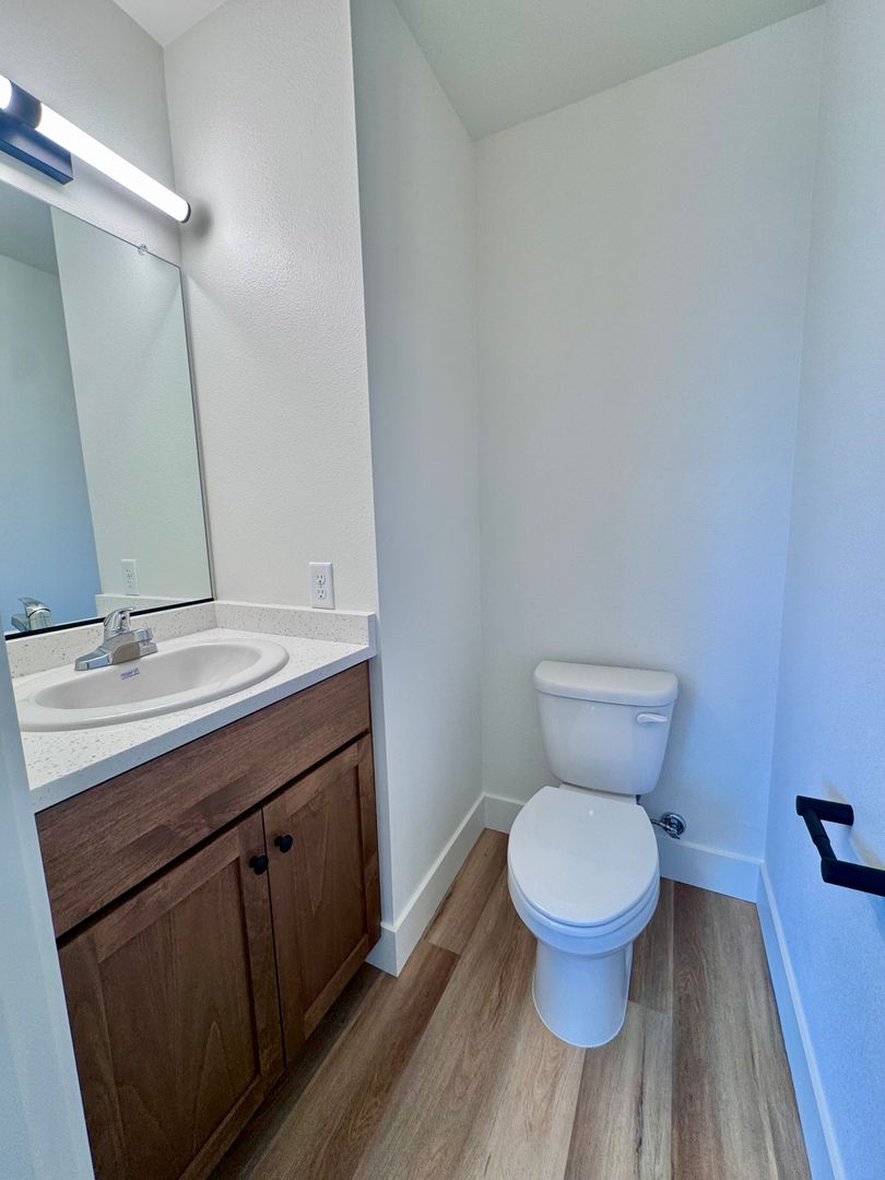 Downstairs half bathroom with vanity and toilet