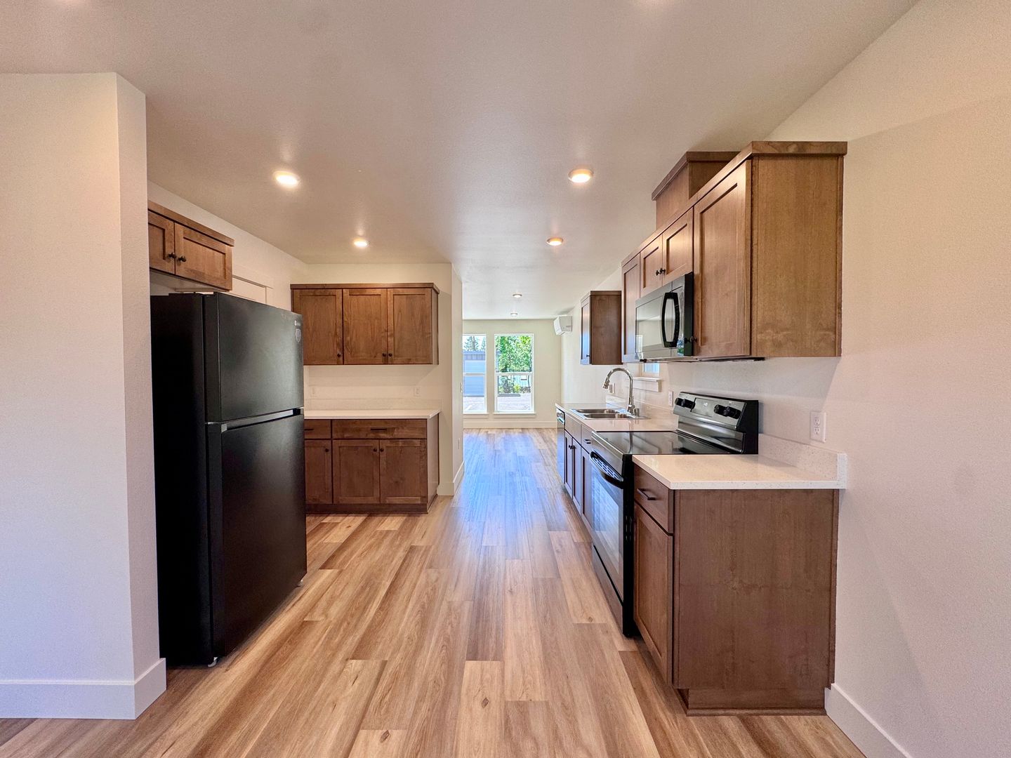 Galley-style kitchen view looking toward the back door and patio