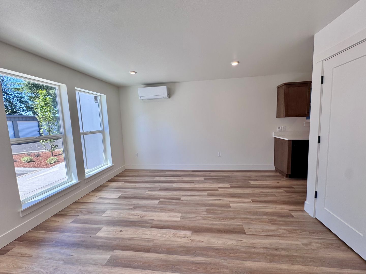 Living room with ductless mini-split and view toward the kitchen