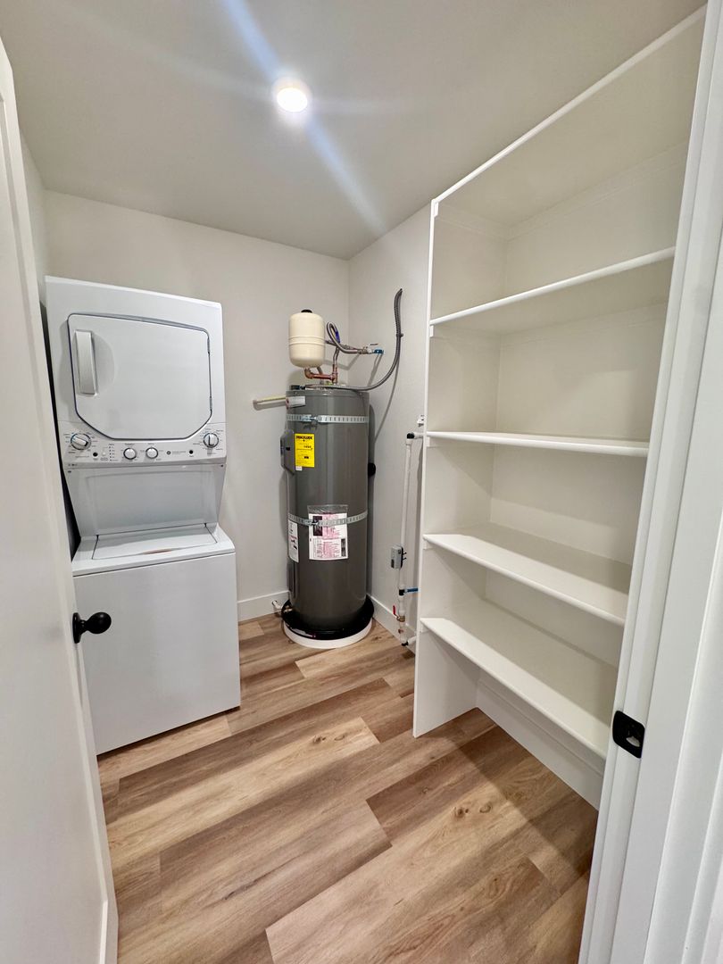 In-unit stacked washer and dryer with walk-in storage shelving