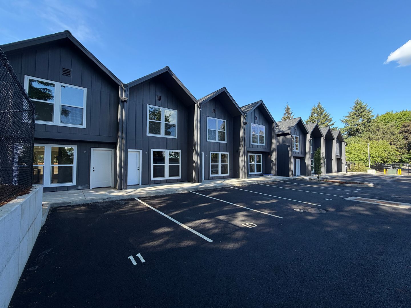Exterior view of 34th Street Townhomes showing Building B units 5 through 8 and parking lot