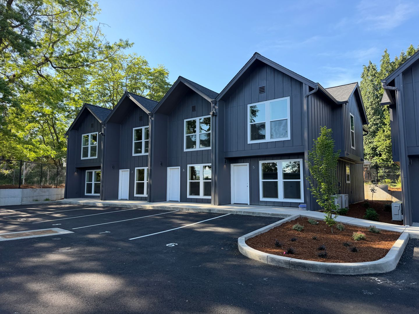 Townhome units 5 through 8 viewed from the opposite end, with new landscaping
