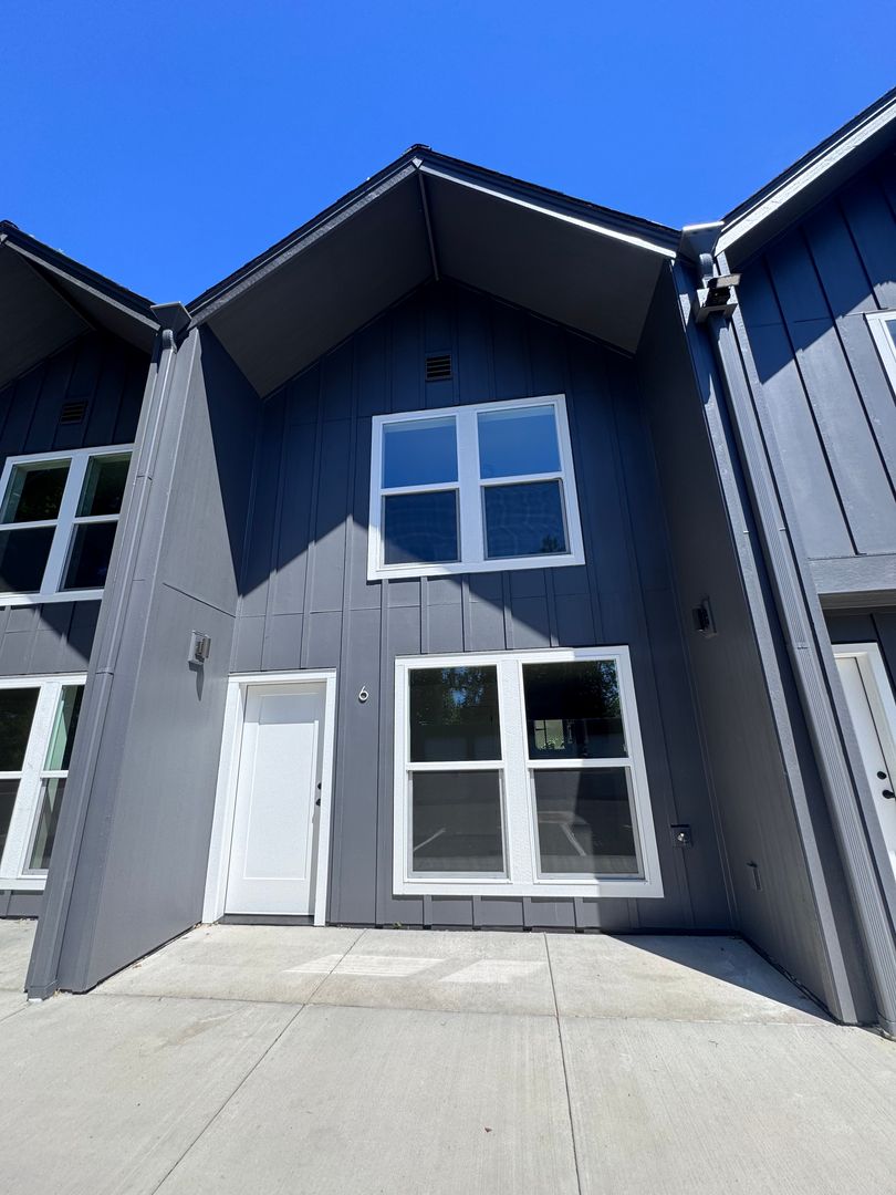 Front entrance of unit 6 with covered porch and large windows